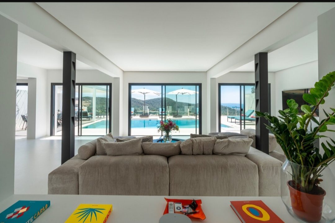Open-plan living room facing the pool and hills