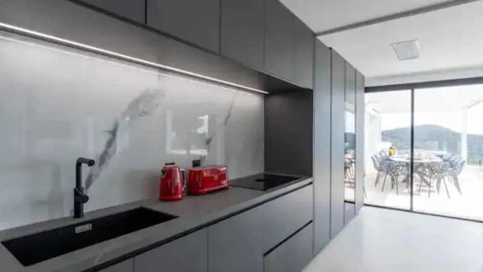 Modern kitchen with dark cabinetry and countertop